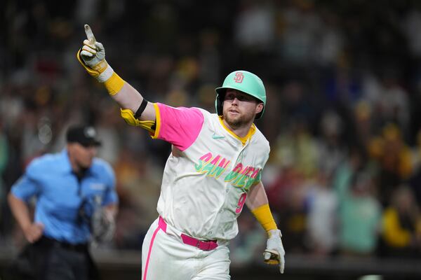 San Diego Padres' Jake Cronenworth celebrates after hitting a home run during the eighth inning of a baseball game against the Atlanta Braves Friday, March 28, 2025, in San Diego. (AP Photo/Gregory Bull)