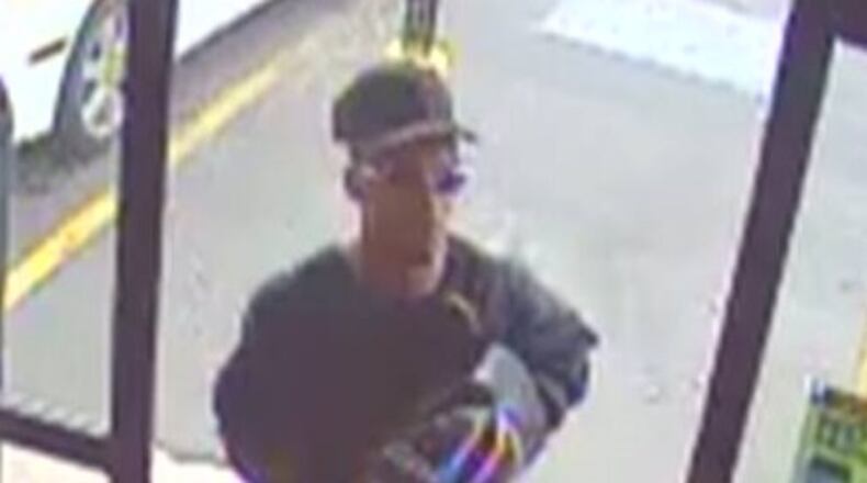 Police said the man pulled a handgun on a pregnant cashier and held it to her head.