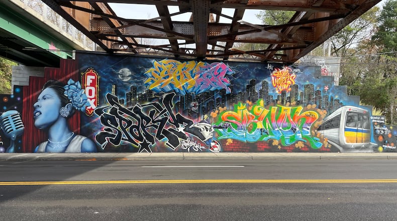 A wall showcases pieces done by Atlanta graffiti artists SAVE and Sparky Z for the 2023 ATL Jam.