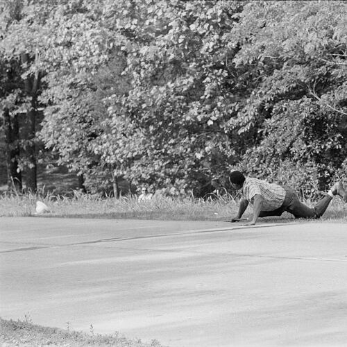 FILE - James Meredith looks at Aubrey James Norvell, background left partially hidden behind foliage, after being shot on a road near Hernando, Miss., June 6, 1966. (AP Photo/Jack Thornell, File)