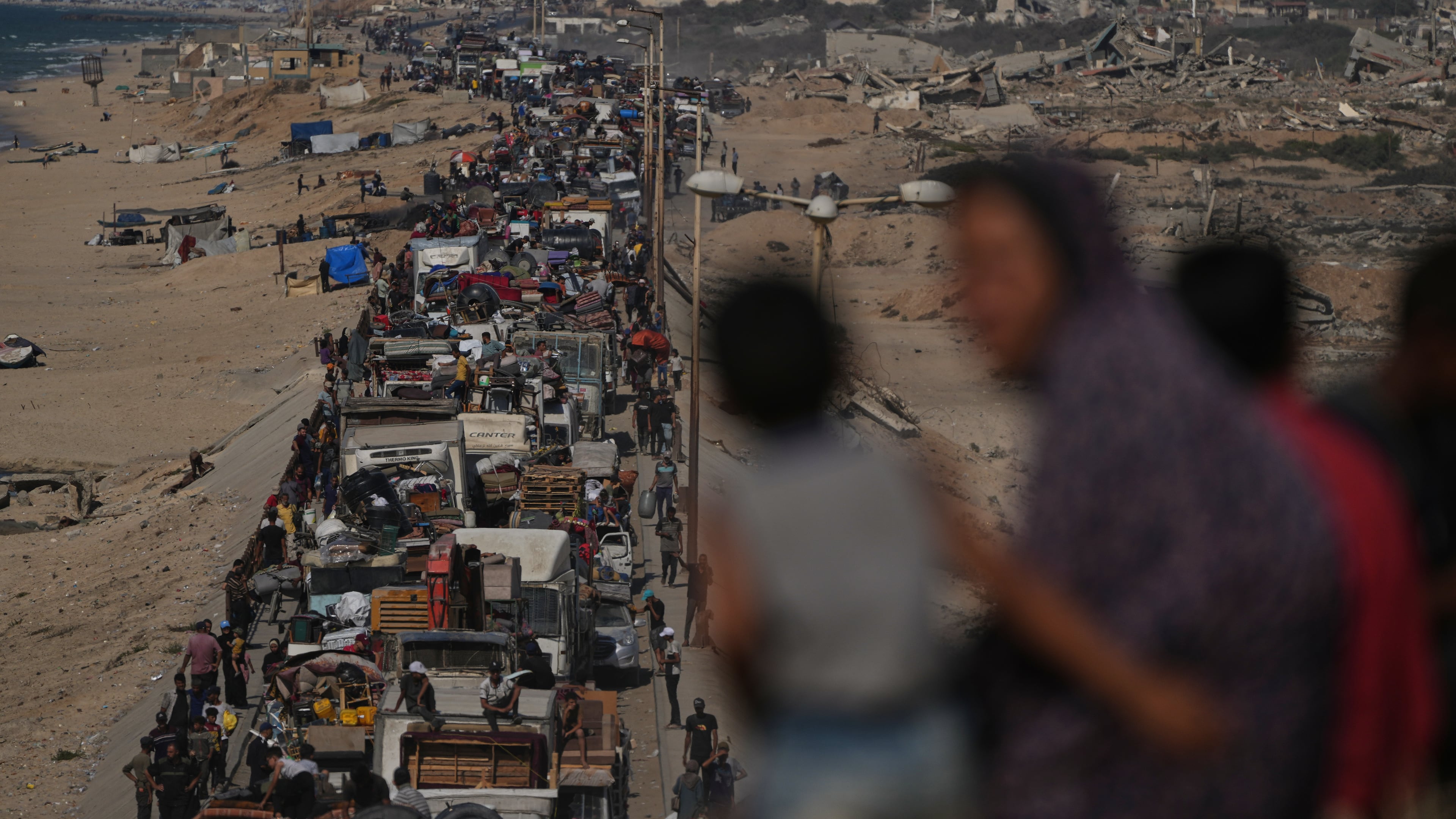Displaced Palestinians flee northern Gaza Strip, by foot and in vehicles, carrying their belongings along the coastal road, near Wadi Gaza, Tuesday, Sept. 23, 2025. (AP Photo/Abdel Kareem Hana)