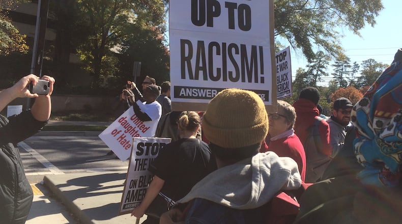 A small group of protesters rallies at the site of the annual convention of the United Daughters of the Confederacy on Saturday in Atlanta. (Photo by Michael E. Kanell/AJC)