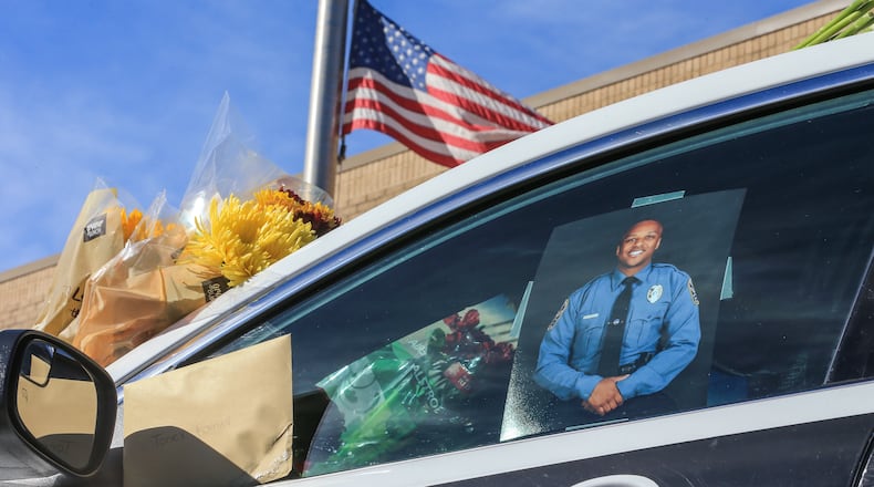 October 22, 2018 Gwinnett County: A memorial to slain Gwinnett County police officer Antwan Toney was in front of the Gwinnett County Police Annex Monday, Oct. 22, 2108 at 800 Hi Hope Rd, in Lawrenceville where flowers, note and candles are growing. JOHN SPINK/JSPINK@AJC.COM