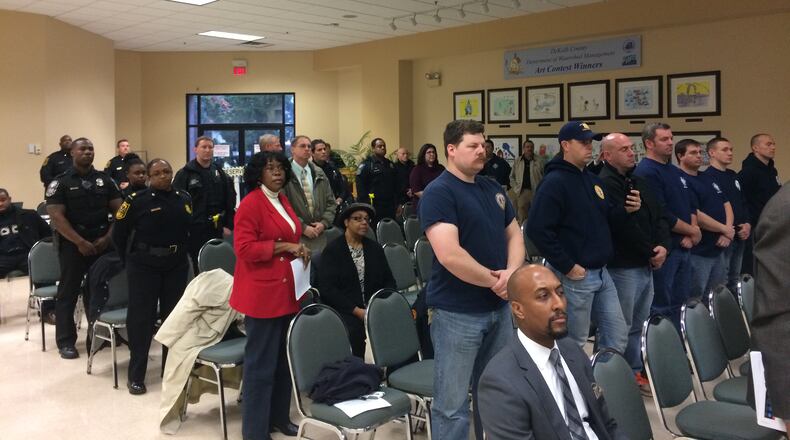 More than two dozen police officers and firefighters stood in solidarity as they asked the DeKalb County Board of Commissioners for a raise on Tuesday, Feb. 9, 2016. MARK NIESSE / MARK.NIESSE@AJC.COM