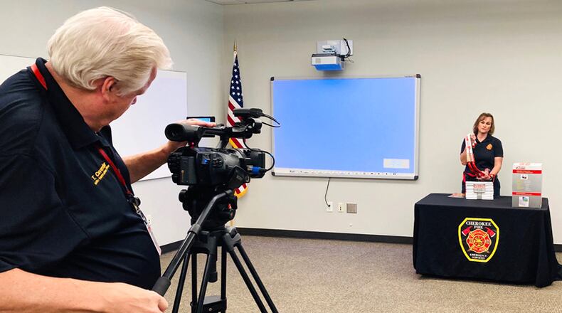 Cherokee Fire Public Information Officer Tim Cavender records Fire Educator Beth Elder for a video on fire safety for the schools.