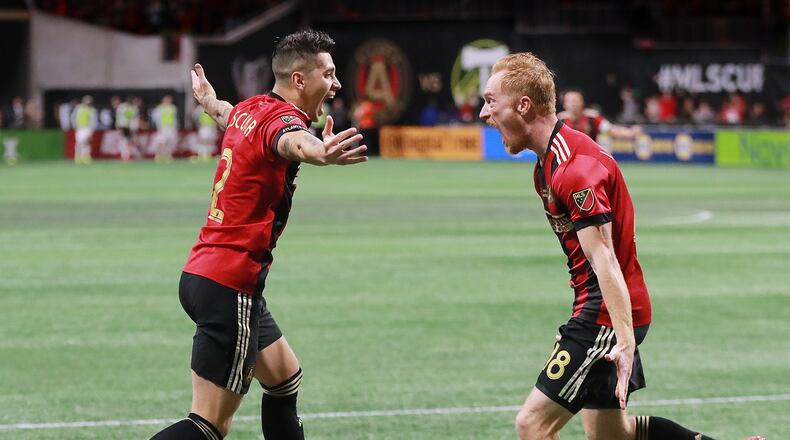 12/8/18 - Atlanta - Atlanta United player Franco Escobar (left) reacts to scoring his goal with teammate jeff Larentowicz against the Portland Timbers for a 2-0 lead in the MLS Cup, the championship game of the Major League Soccer League at Mercedes-Benz Stadium in Atlanta.   CURTIS COMPTON / CCOMPTON@AJC.COM