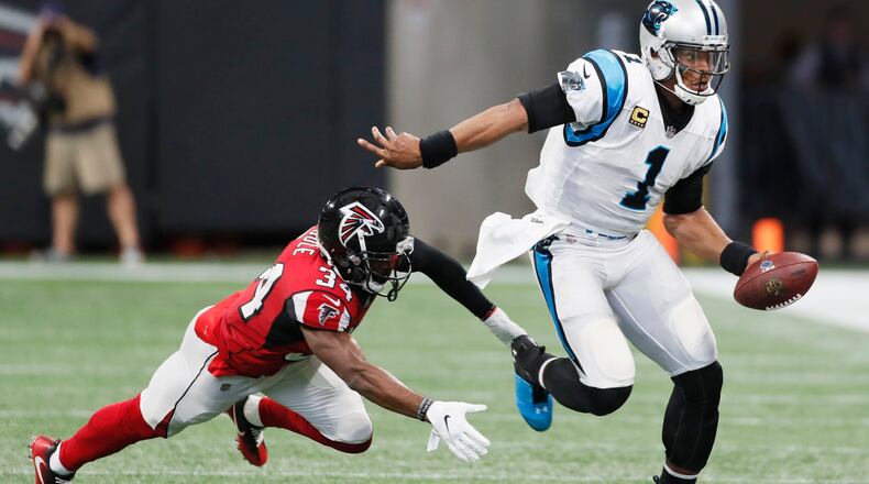 Carolina Panthers quarterback Cam Newton (1) evades Atlanta Falcons cornerback Brian Poole (34) on a keeper in the second half.
