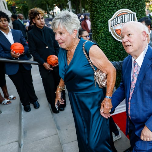 Veteran NBA referee and 2026 inductee Joey Crawford, right, recognizes his image on the columns of Symphony Hall as he enters the 2026 Naismith Basketball Hall of Fame induction ceremony Saturday, Aug. 15, 2026, in Springfield, Mass. (AP Photo/Rusty Jones)