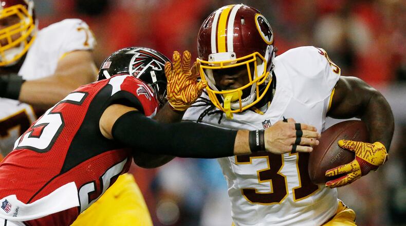 Washington Redskins running back Matt Jones (31) runs against Atlanta Falcons middle linebacker Paul Worrilow (55) during the first half of a preseason NFL football game, Thursday, Aug. 11, 2016, in Atlanta. (AP Photo/Brynn Anderson)