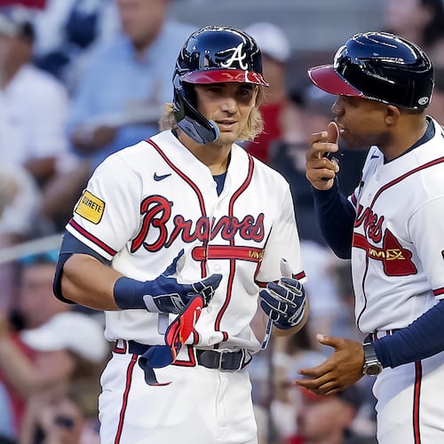 The Braves' Jim Jarvis (left) reacts with first base coach Antoan Richardson after hitting an RBI single against the Mets during the second inning Monday, July 6, 2026, in Atlanta. (Erik S. Lesser/AP)