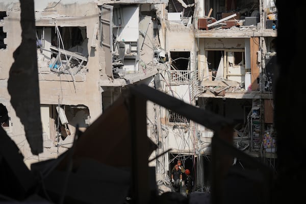Israeli first responders work in the rubble of a residential building hit by a missile fired from Iran, near Tel Aviv, Israel, Sunday, June 15, 2025. (AP Photo/Ariel Schalit)