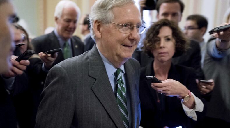 Senate Majority Leader Mitch McConnell of Kentucky walks onto the U.S. Senate floor Thursday following a meeting with Senate Republicans on their long-awaited health care plan. The Congressional Budget Office has now said that plan could lead to 22 million fewer insured Americans, which could include 680,000 Georgians. (AP Photo/Andrew Harnik)