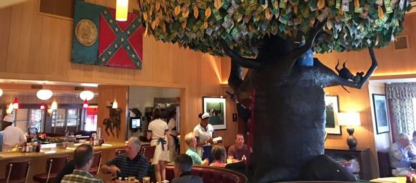 The wood carving of Georgia's 1956 state flag, complete with Rebel emblem, was moved to the back dining area. Courtesy Tony Wilbert.