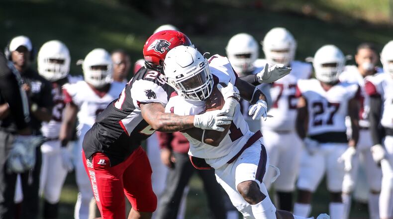 Morehouse Maroon Tigers running back Santo Dunn (1) runs the ball while being defended by Clark Atlanta Panthers linebacker Tyrone Mixer (25) players during a college football game, Saturday, Nov. 3, 2018, in Atlanta. BRANDEN CAMP/SPECIAL