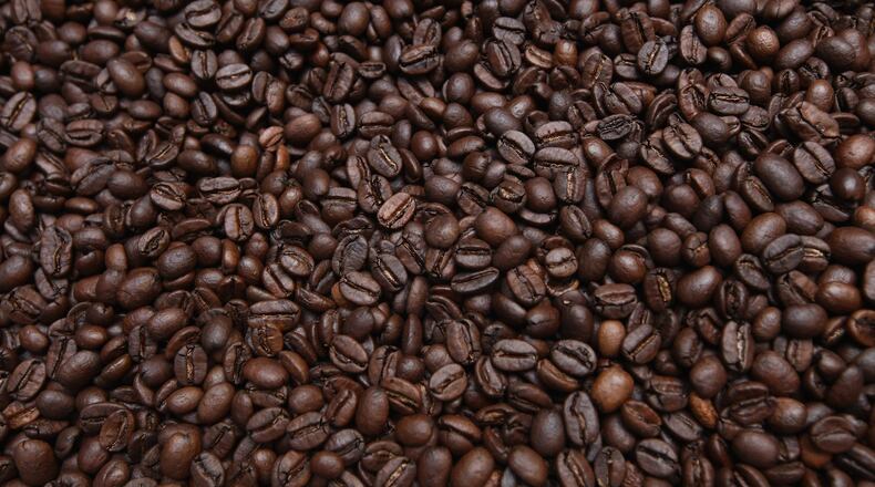 Freshly-roasted espresso coffee beans sit to cool. (Photo by Sean Gallup/Getty Images)