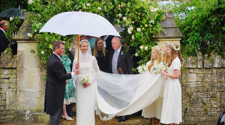 Bride Harriet Sperling and bride groom Peter Phillips, accompanied by bridesmaids after their wedding ceremony at All Saints Church in Kemble, Gloucestershire, England, Saturday, June 6, 2026. (Ben Birchall/PA via AP)
