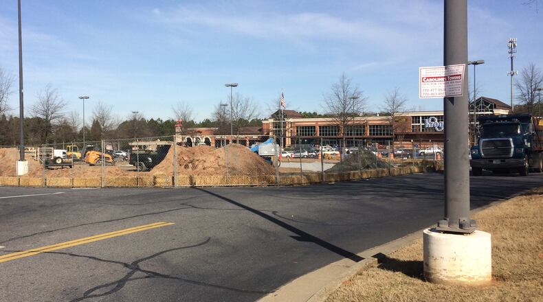 Readers are curious about what’s being built in the parking lot in front of the Kroger on Holcomb Bridge Road.