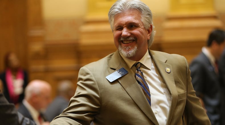 Sen. Greg Kirk (R-Americus) winks and shakes hands after the “religious liberty” bill he sponsored in the Senate passed on March 16. Ben Gray / bgray@ajc.com