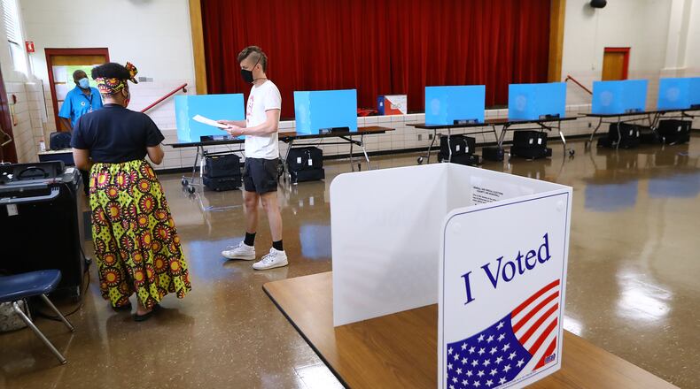 U.S. District Judge Amy Totenberg will soon rule on motions to discard Georgia's new $104 million voting system, conduct more stringent audits of election results and require updated paper voter registration lists at polling places, such as this one at Flat Shoals Elementary School in Atlanta. Curtis Compton ccompton@ajc.com