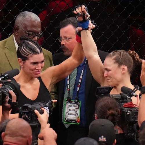 Ronda Rousey, of the United States, right, celebrates after defeating Gina Carano, of the United States, left, in their featherweight mixed martial arts fight Saturday, May 16, 2026, in Inglewood, Calif. (AP Photo/Jae C. Hong )