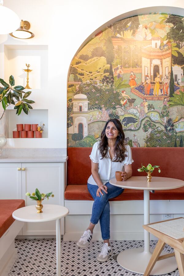 A woman sits in a modern tea shop