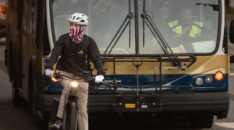 Teddy Oldham, 21 and a third-year student at Georgia Tech, was wrapped up Wednesday morning, Oct. 16, 2024 as he rode through campus and paused at Fowler Street and Ferst Drive. (John Spink/AJC)