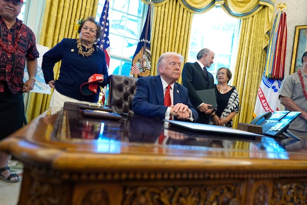 President Donald Trump waits as members of the press are escorted out of the Oval Office after he signed executive orders in the Oval Office of the White House, Thursday, April 17, 2025, in Washington. (AP Photo/Alex Brandon)