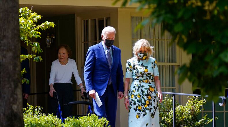 President Joe Biden and first lady Jill Biden walk with former first lady Rosalynn Carter as they leave the home of former President Jimmy Carter during a trip to mark Biden's 100th day in office, Thursday, April 29, 2021, in Plains, Ga. (AP Photo/Evan Vucci)