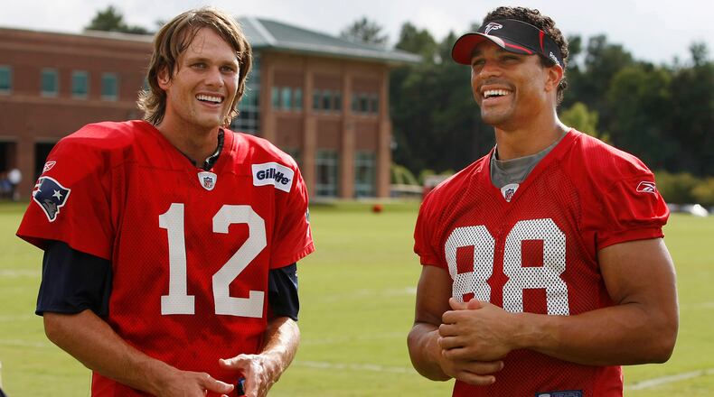 Tom Brady (12) shares a laugh with Tony Gonzalez (88) during a combined training camp practice between the New England Patriots and Atlanta Falcons Tuesday, Aug. 17, 2010, in Flowery Branch.