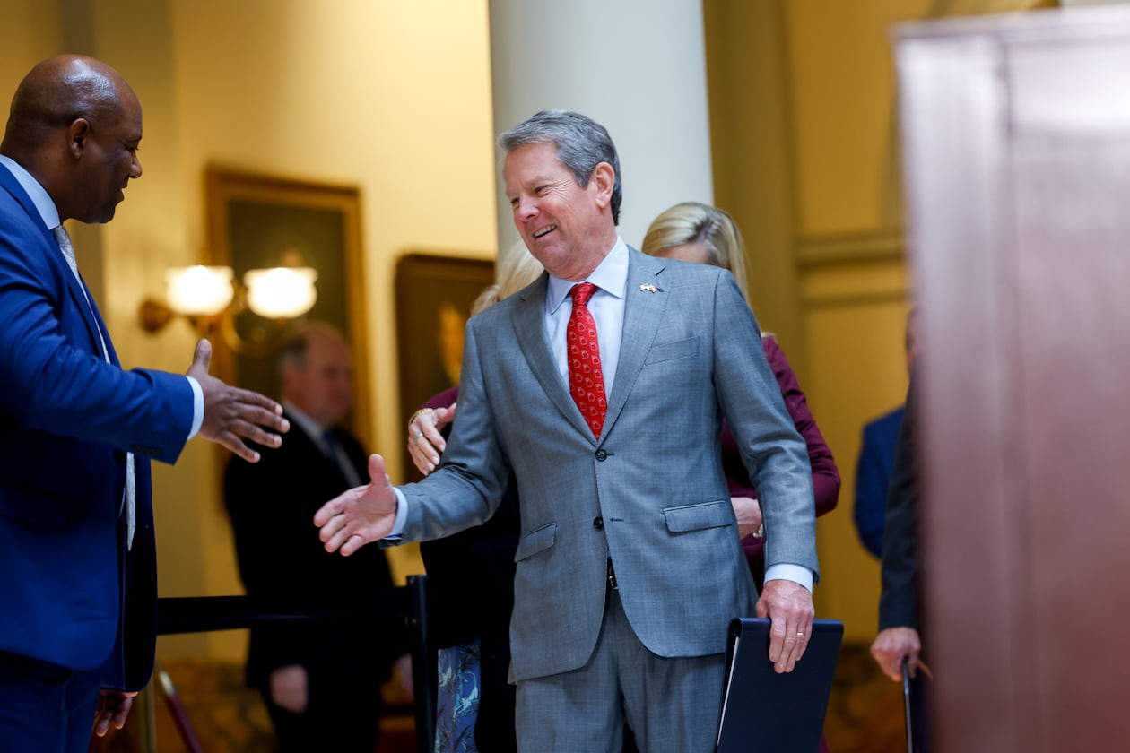 Gov. Brian Kemp walks in to a news conference to sign the budget bill at the Capitol on Tuesday. (Arvin Temkar/AJC)