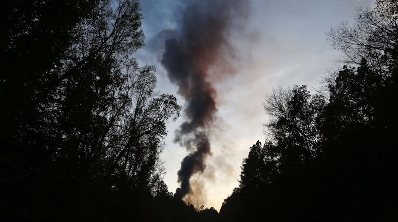 A plume of smoke rises from the site of an explosion on the Colonial Pipeline on Monday, Oct. 31, 2016, in Helena, Ala. (AP Photo/Brynn Anderson)