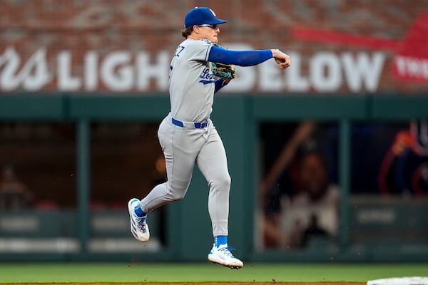Los Angeles Dodgers first baseman Enrique Hernández (8) makes the throw to first base against Atlanta Braves' Drake Baldwin in the fourth inning of a baseball game, Sunday, May 4, 2025, in Atlanta. (AP Photo/Mike Stewart)
