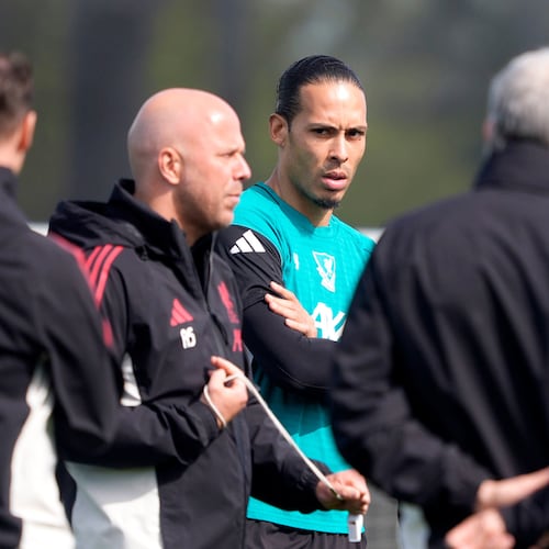 Liverpool's Virgil van Dijk, center, and manager Arne Slot, second left, attend a training session in Liverpool, England, Tuesday April 7, 2026. (Peter Byrne/PA via AP)