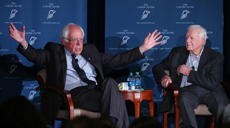Former President Jimmy Carter and U.S. Sen. Bernie Sanders discuss human rights at the Carter Center on Monday. Curtis Compton, ccompton@ajc.com