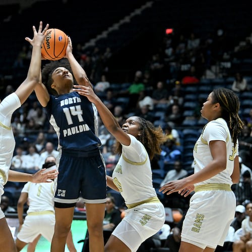 North Paulding Talya Arnold grabs a rebound over Grayson's Mya Glover (second from left) and London Backman-Grier (second from right) during the first half in Class 6A girls GHSA state championship at the Macon Coliseum, Saturday, March 14, 2026, in Macon. (Hyosub Shin/AJC)