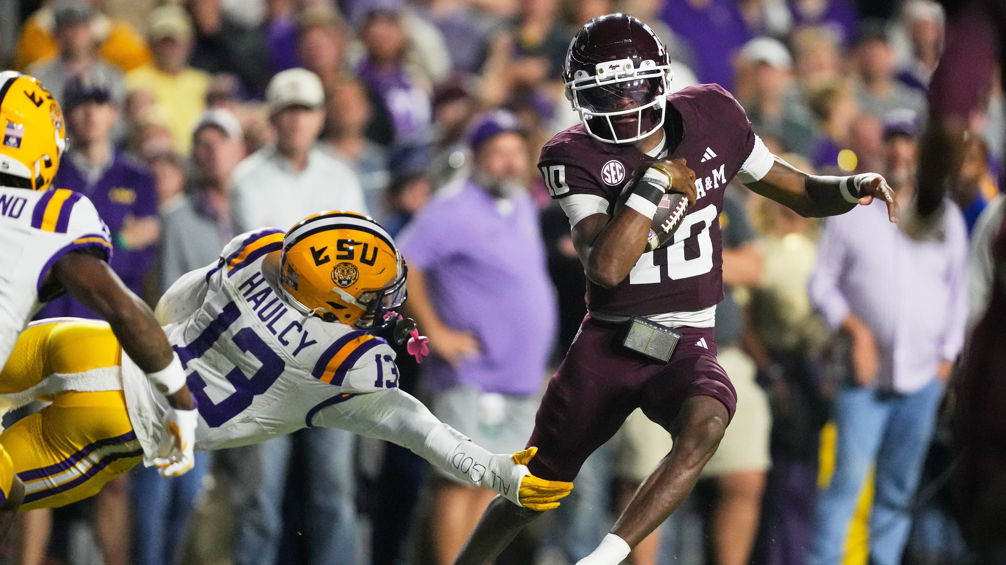 Texas A&M quarterback Marcel Reed (10) carries for a touchdown against LSU defensive back A.J. Haulcy (13) in the first half of an NCAA college football game, Saturday, Oct. 25, 2025 in Baton Rouge, La. (AP Photo/Gerald Herbert)