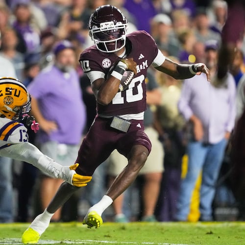 Texas A&M quarterback Marcel Reed (10) carries for a touchdown against LSU defensive back A.J. Haulcy (13) in the first half of an NCAA college football game, Saturday, Oct. 25, 2025 in Baton Rouge, La. (AP Photo/Gerald Herbert)