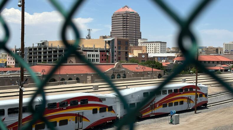 The tallest building in downtown Albuquerque, N.M., which houses the U.S. attorney's office, is seen beyond a chain link fence on Friday, June 12, 2026. (AP Photo/Susan Montoya Bryan)
