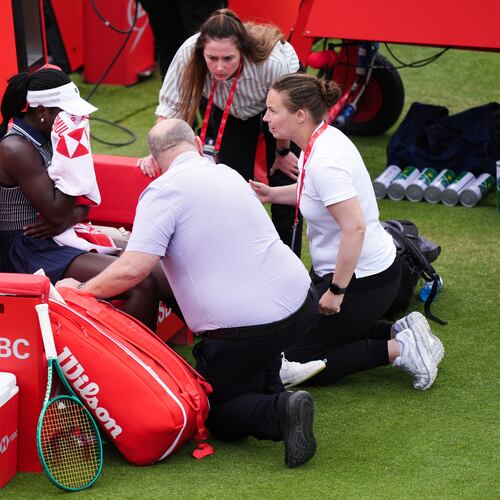 Victoria Mboko, left, of Canada retires injured during her match against Karolina Pliskova of Czech Republic on day three of the Queen's Club tennis championships in London, Wednesday, June 10, 2026. (Ben Whitley/PA via AP)