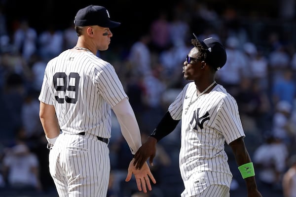 New York Yankees' Aaron Judge (99) and Jazz Chisholm Jr., right, celebrate after they defeated the Athletics in a baseball game Sunday, June 29, 2025, in New York. (AP Photo/Adam Hunger)