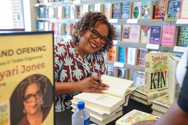 Atlanta author Tayari Jones signs her book, "Kin," for fans during the Barnes & Noble grand opening on Moreland Avenue on July 8, 2026. (Jason Getz/AJC)