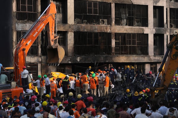 Search and rescue teams respond to the scene of a plane crash in Ahmedabad, India, Thursday, June 12, 2025. (AP Photo/Ajit Solanki)