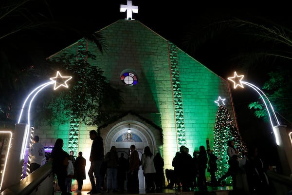 FILE - Palestinian Christians wait to pray at the midnight Christmas Eve mass out side the Deir Al Latin Holy Family Catholic Church in Gaza City, Dec. 24, 2021. (AP Photo/Adel Hana, file)