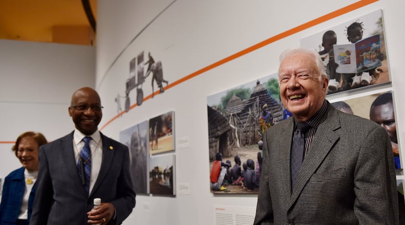 In this 2017 photo,- former President Jimmy Carter, right, Dr. Donald Hopkins, center, and Rosalynn Carter, far left, give a tour of an exhibition on disease eradication at the Jimmy Carter Presidential Library and Museum in Atlanta. The Carter Center has aided in the near extinction of Guinea worm disease. (DAVID BARNES / DAVID.BARNES@AJC.COM)