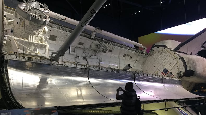 The retired space shuttle Atlantis is on display at the Kennedy Space Center, where visitors can peek into the hold and walk below the heat-shield tiles. CONTRIBUTED BY H.M. CAULEY