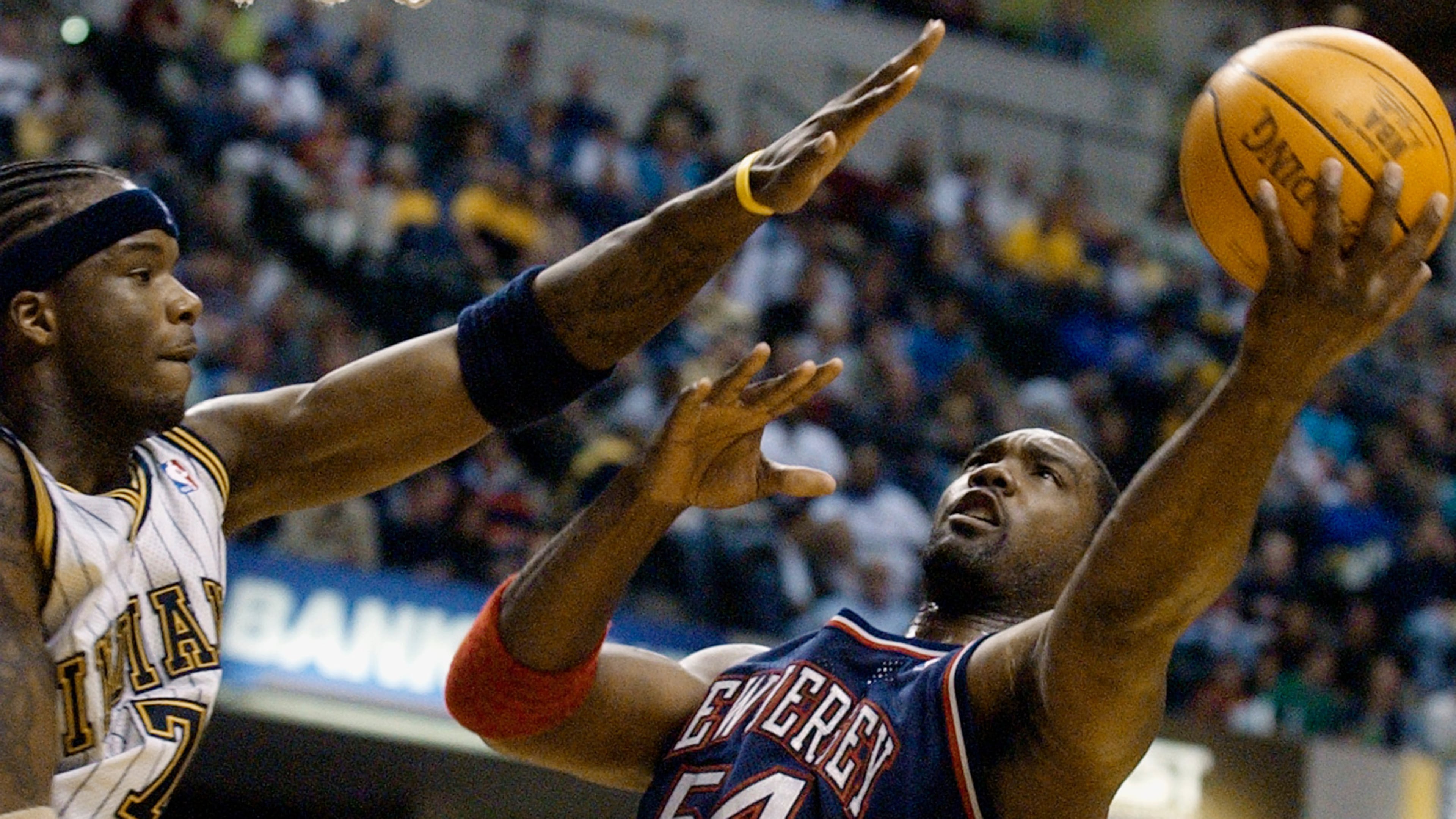 FILE - New Jersey Nets forward Rodney Rogers puts up a shot against Indiana Pacers forward Jermaine O'Neal during the first quarter of a basketball game in Indianapolis, April 9, 2004. (AP Photo/Darron Cummings, File)