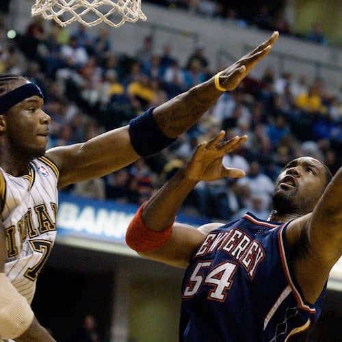 FILE - New Jersey Nets forward Rodney Rogers puts up a shot against Indiana Pacers forward Jermaine O'Neal during the first quarter of a basketball game in Indianapolis, April 9, 2004. (AP Photo/Darron Cummings, File)