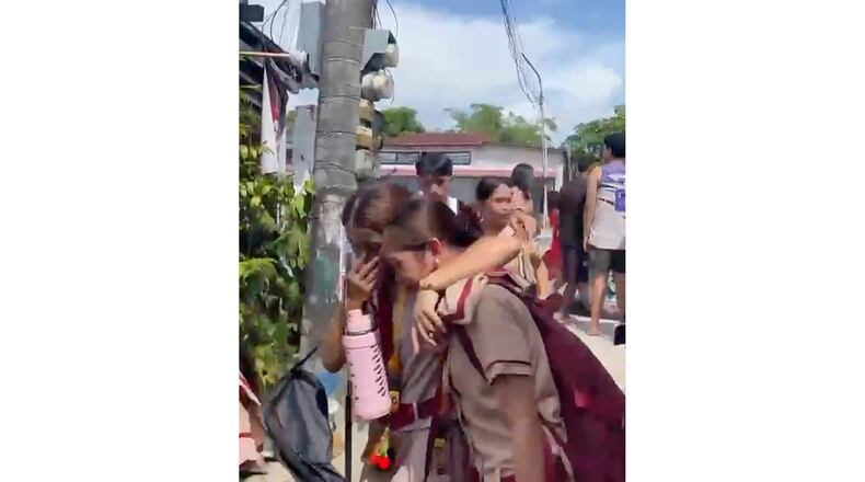 In this photo taken from a video, students react after a shooting incident at the San Jose National High School in Tacloban city, Philippines Monday, June 22, 2026. (James Daantos via AP Photo)