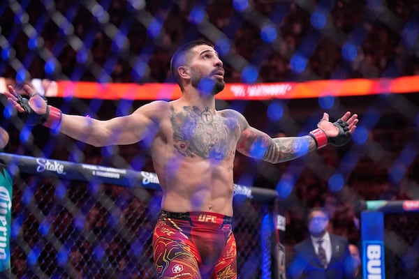 Ilia Topuria celebrates after defeating Charles Oliveira in a lightweight title fight at UFC 317, Saturday, June 28, 2025, in Las Vegas. (AP Photo/John Locher)