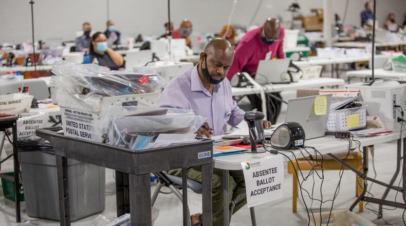 Gwinnett Voter Registations and Elections office is busy with poll workers delivering ballots and scanned data as well as counting absentee ballots and organize provisional ballots on Tuesday, Nov 3, 2020.  (Jenni Girtman for The Atlanta Journal-Constitution)